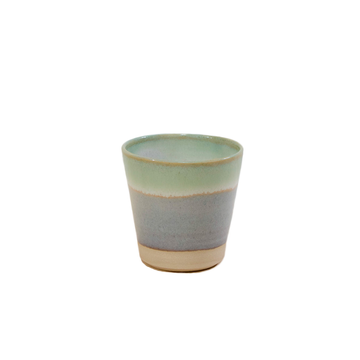 De AB Ceramics Beker Wit Opaal/Lichtgroen 20 cl is een kleine, handgemaakte beker van keramiek met een matte afwerking en een subtiel kleurverloop in opaalwit en lichtgroen, afgewerkt met een naturel beige basis. Dit minimalistische ontwerp is van AB Ceramics.