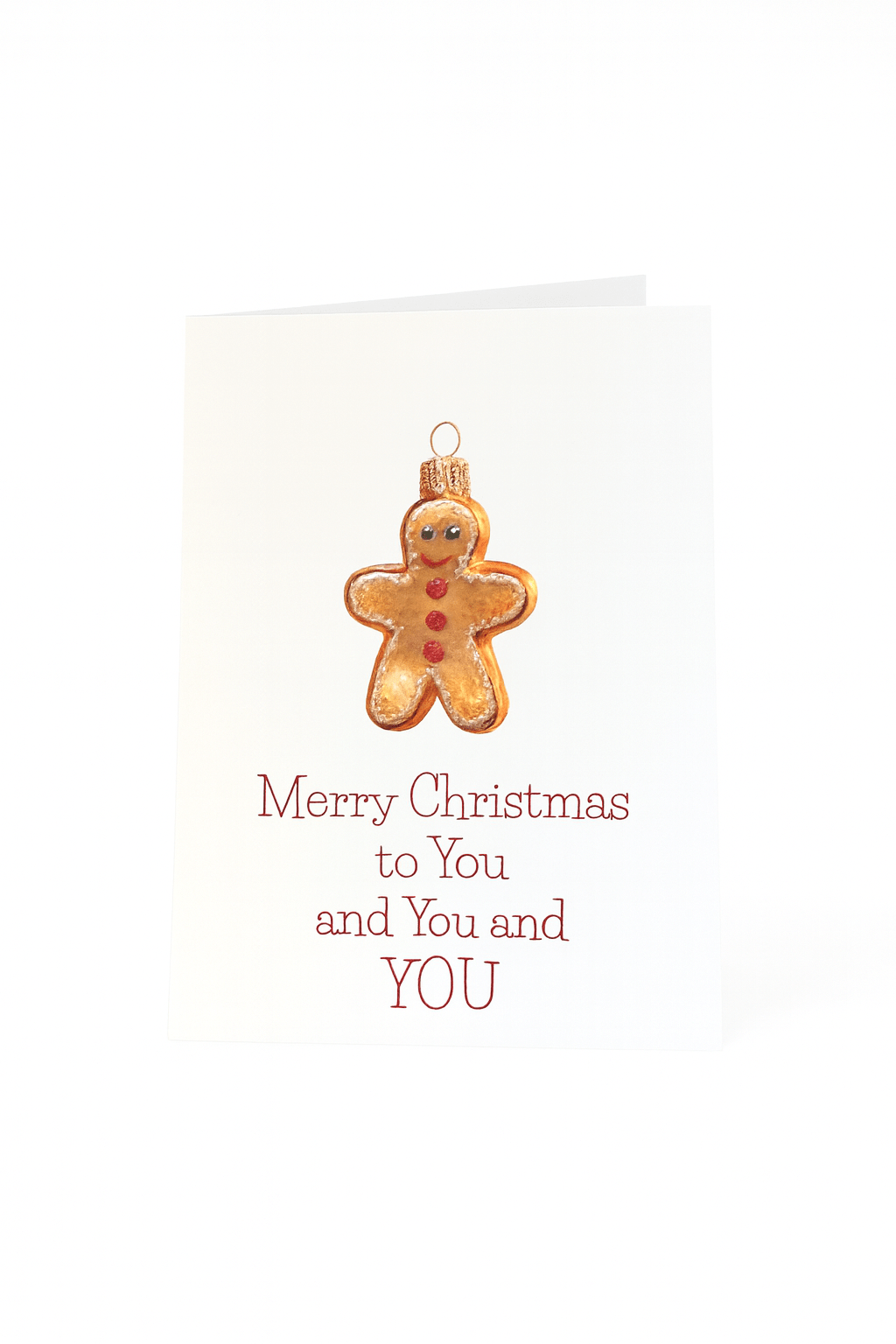 De Matriks Kerstkaart Merry Christmas to You, You and You! van Matriks heeft een unikerstbal in de vorm van een peperkoekje en de boodschap "Merry Christmas to You, You and YOU" in rood op een witte achtergrond.