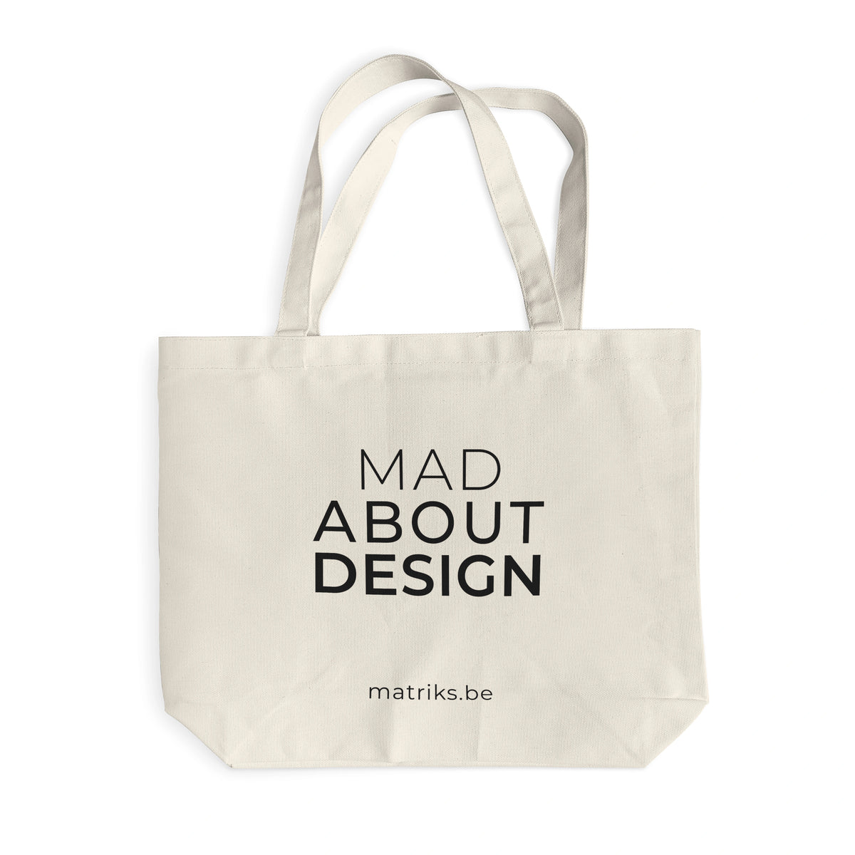 De Matriks Mad About Design Tote Bag van Matriks is een beige canvas tas van duurzaam materiaal, met "MAD ABOUT DESIGN" in zwart en mitriks.com eronder - een must-have voor elke designliefhebber, afgebeeld op een witte achtergrond.