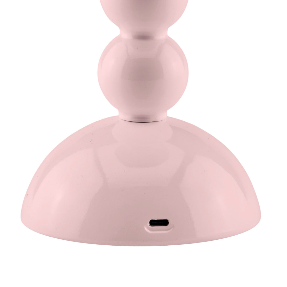 Een close-up van de Addison Ross Bobbin Lamp LED Oplaadbaar Roze toont de lichtroze, afgeronde voet met een USB-C poort-perfecte sfeerverlichting, geïnspireerd op het elegante draadloze ontwerp van Addison Ross.