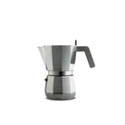 De Alessi Moka Espresso Koffiemaker 3-kops is een zilveren mokapot met een zwart handvat van Alessi, geïsoleerd afgebeeld op een witte achtergrond.