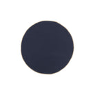 Een marineblauwe, ronde stoffen servet met een lichte rand en een licht ongelijkmatige rand - Broste Copenhagen's Wilhelmina Servet Donkerblauw D45 - op een witte achtergrond.