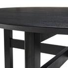 Close-up van de Hubsch Fjord Eettafel Essenhout Zwart D120: een zwarte ronde houten tafel van Hubsch, met stevige poten en kruisende steunbalken eronder.