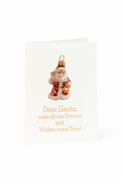 Op de Matriks Kerstkaart Dear Santa, ... staat de Kerstman met een zuurstok en de boodschap: "Lieve Kerstman, laat al onze dromen en wensen uitkomen!" van Matriks - perfect voor je feestelijke kerstgroeten.