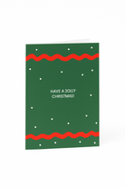 Stuur feestelijke wensen met de Matriks Kerstkaart Have a Jolly Christmas! van Matriks - een groene kaart met rode golvende randen, kleine witte stippen en "HAVE A JOLLY CHRISTMAS!" in het midden.