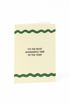 Stuur feestelijke groeten met de Matriks Kerstkaart "It's the Most Wonderful Time of the Year!"- een unieke crèmekleurige kaart met groene golvende lijnen, witte stippen en een vrolijke vakantieboodschap van Matriks.