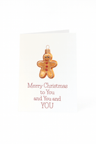 De Matriks Kerstkaart Merry Christmas to You, You and You! van Matriks heeft een unikerstbal in de vorm van een peperkoekje en de boodschap "Merry Christmas to You, You and YOU" in rood op een witte achtergrond.
