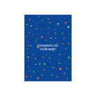 De Matriks JL Postkaart Congrats On Your Baby Blue Dubbel van Matriks heeft kleurrijke confetti stippen op een blauwe achtergrond met "CONGRATS ON YOUR BABY!" in witte tekst in het midden.