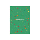 De Matriks JL Postkaart Good Luck Green Dubbel van Matriks heeft een groen ontwerp met gele en rode confetti-achtige stippen en vetgedrukte witte "GOOD LUCK!" tekst midden op de voorkant. Ontwerp door Julie Lindekens.