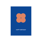 De Matriks JL Postkaart Happy Birthday Navy Dubbel van Matriks heeft een eenvoudig oranje bloemachtig ontwerp op een navy kaart met daaronder "HAPPY BIRTHDAY" in witte tekst.