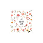 Een witte vierkante kaart met aquarel bloemen en bladeren omlijst "OH HAPPY DAY" in zwart. Perfect voor tafelschikking of in combinatie met PPD Papieren Servetten Oh Happy Day 33/33, 3-laags FSC papier van PPD.