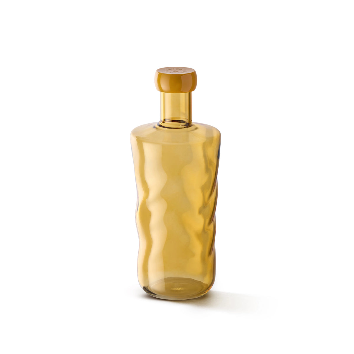Een hoge, transparante amberkleurige Paveau Swirl Waterfles Dune Geel 1,25 l met bijpassende ronde stop en golvende textuur van Paveau is afgebeeld op een witte achtergrond-een stijlvol cadeau voor elke gelegenheid.