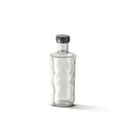 De Paveau Swirl Waterfles Mist Smoke 0,75 l van Paveau staat rechtop op een witte achtergrond, met helder golvend borosilicaatglas en een donkergroene ronde dop.