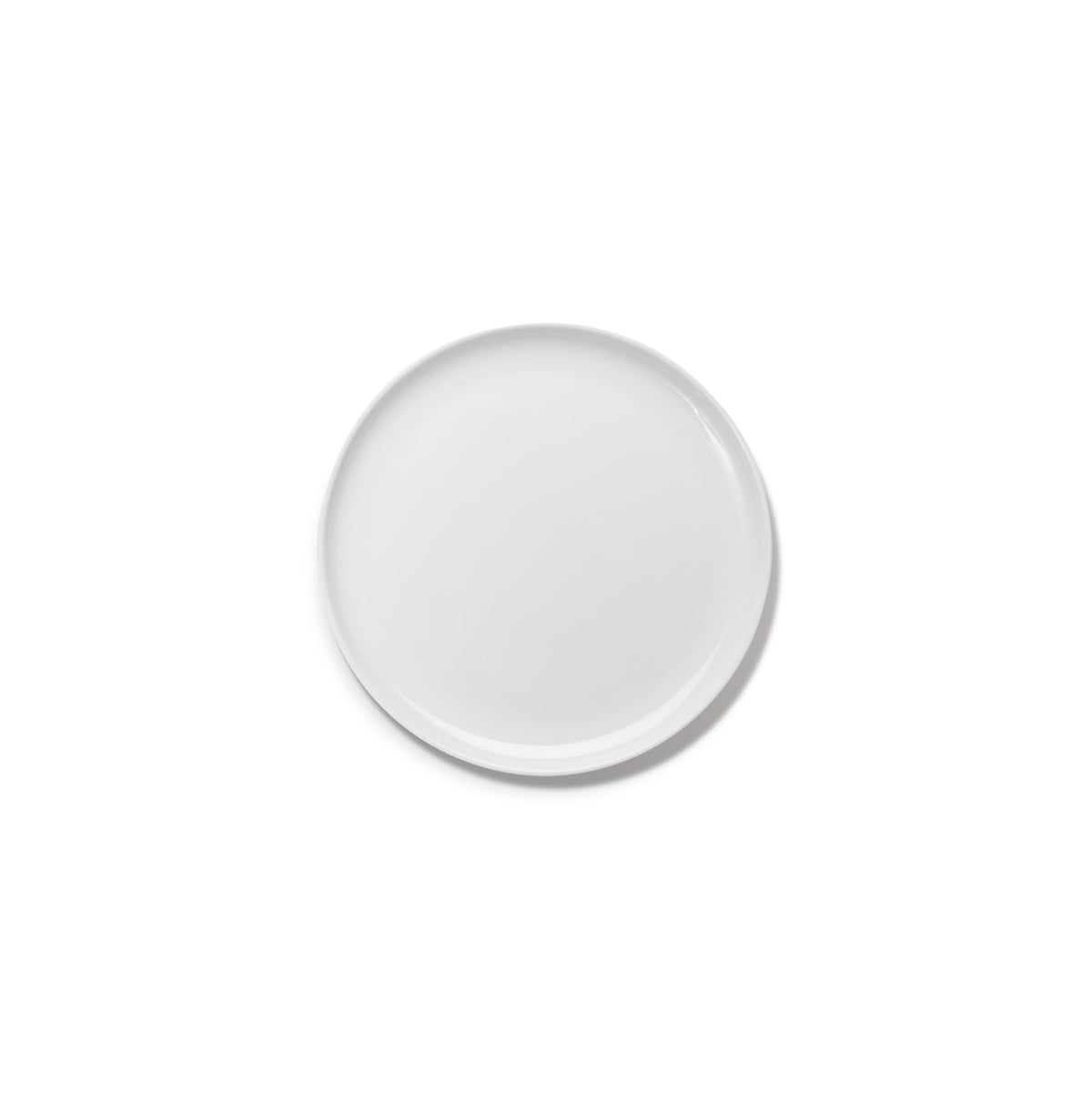 Een effen, rond, wit keramiek Serax Base Laag Bord D24 bord van het merk Serax, gefotografeerd tegen een witte achtergrond.